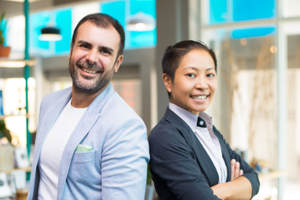 happy-asian-latin-managers-smiling-standing-side-by-side.png